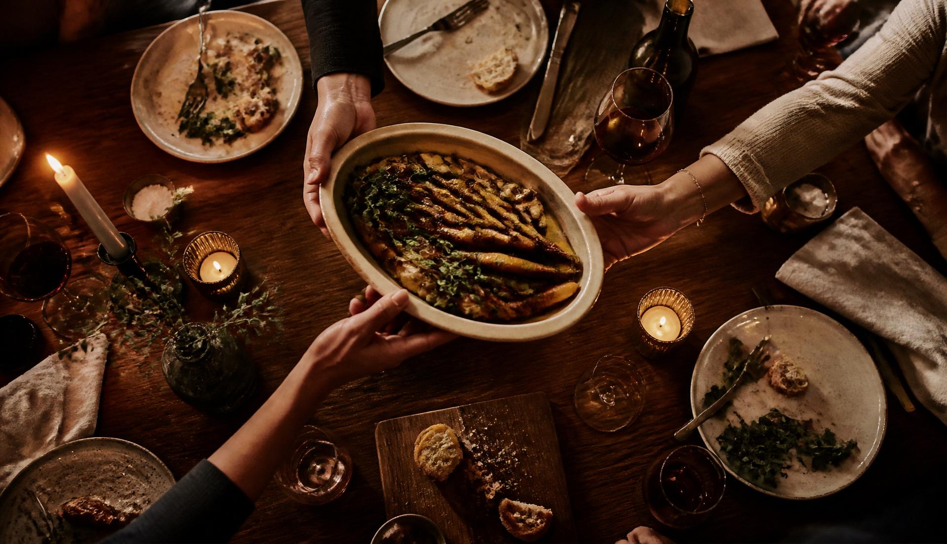 A family gathered around a candlelit table at the close of dinner